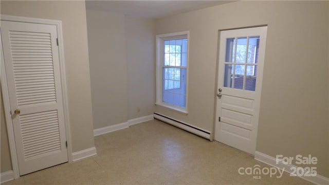 1245 Paddock Cir, Charlotte, NC 28209 - doorway with baseboard heating, baseboards, and light flooring