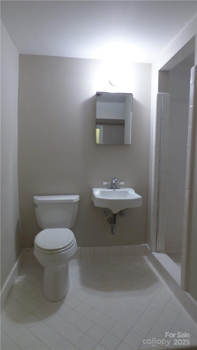 1245 Paddock Cir, Charlotte, NC 28209 - full bath featuring tile patterned flooring, toilet, a shower stall, and a sink