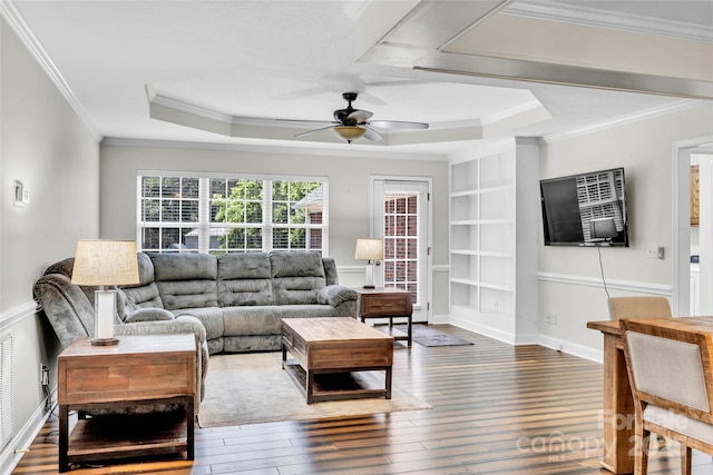 2005 Schofield Pl, Salisbury, NC 28144 - living area featuring a ceiling fan, wood-type flooring, ornamental molding, built in shelves, and a tray ceiling