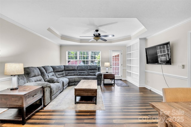 2005 Schofield Pl, Salisbury, NC 28144 - living area featuring ornamental molding, wood finished floors, built in features, a ceiling fan, and a raised ceiling