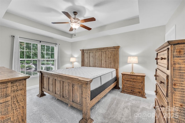 2005 Schofield Pl, Salisbury, NC 28144 - bedroom featuring a raised ceiling, light carpet, baseboards, and ceiling fan
