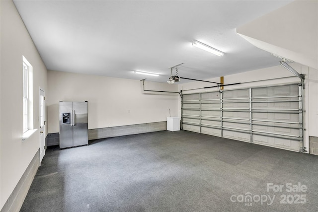 2005 Schofield Pl, Salisbury, NC 28144 - garage with stainless steel fridge and a garage door opener