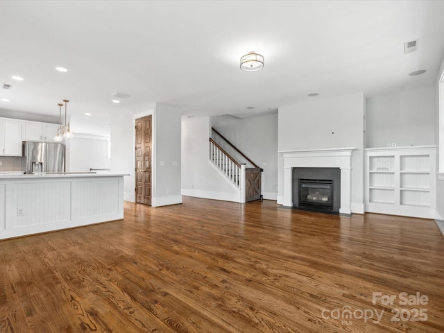 807 Herrons Ferry Rd, Rock Hill, SC 29730 - unfurnished living room featuring dark wood-style flooring, stairs, recessed lighting, a fireplace with flush hearth, and baseboards