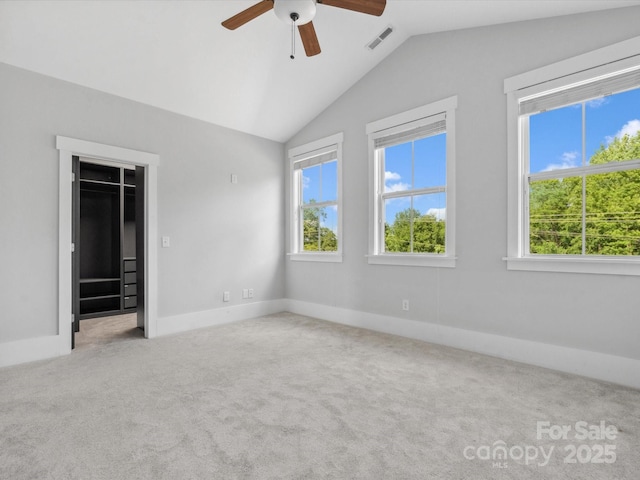 807 Herrons Ferry Rd, Rock Hill, SC 29730 - unfurnished bedroom featuring multiple windows, carpet flooring, vaulted ceiling, a walk in closet, and baseboards