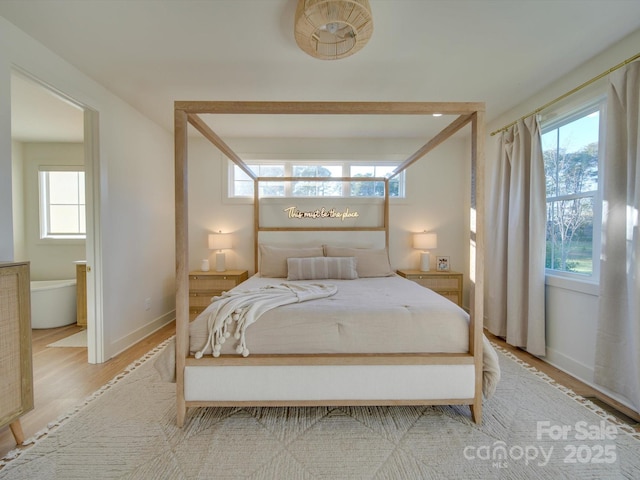 8039 Mcconnell Rd, Denver, NC 28037 - bedroom featuring multiple windows, light wood finished floors, and baseboards
