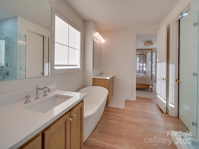 8039 Mcconnell Rd, Denver, NC 28037 - full bath with plenty of natural light, a shower stall, wood finished floors, and two vanities