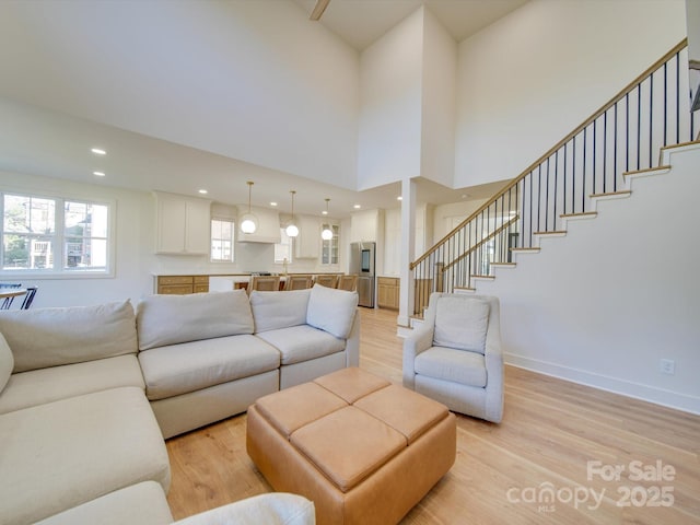 8039 Mcconnell Rd, Denver, NC 28037 - living room with light wood-style floors, stairs, baseboards, and recessed lighting