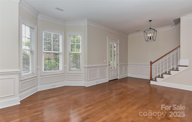 17210 Sulky Plough Rd Unit 1206, Charlotte, NC 28277 - foyer featuring a chandelier, wood finished floors, stairway, wainscoting, and a decorative wall