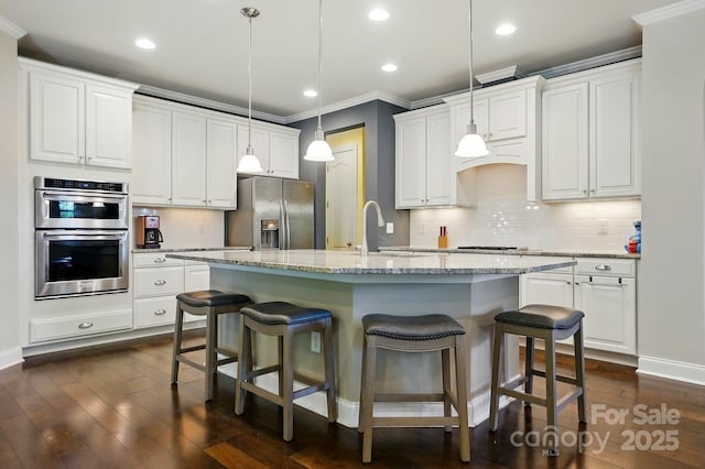 3808 Halcyon Dr, Huntersville, NC 28078 - kitchen with appliances with stainless steel finishes, a sink, crown molding, a breakfast bar, and white cabinets