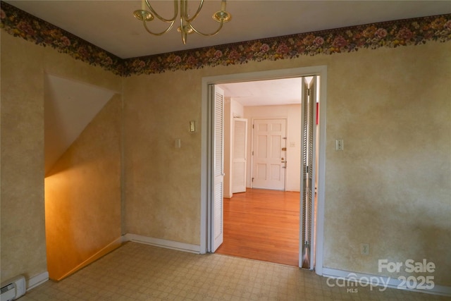 170 Heritage Ln, Salisbury, NC 28147 - spare room featuring tile patterned floors, a chandelier, baseboard heating, and baseboards