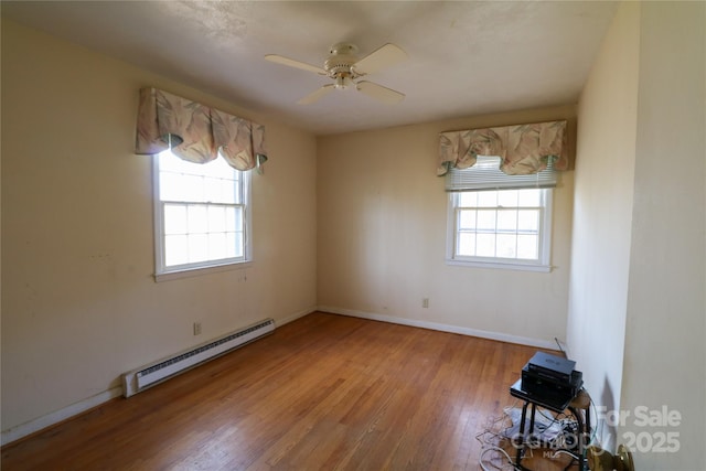 170 Heritage Ln, Salisbury, NC 28147 - empty room with a baseboard heating unit, plenty of natural light, light wood-style flooring, and a ceiling fan