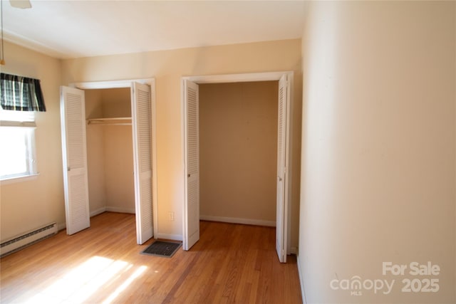 170 Heritage Ln, Salisbury, NC 28147 - unfurnished bedroom featuring light wood-style floors and baseboard heating