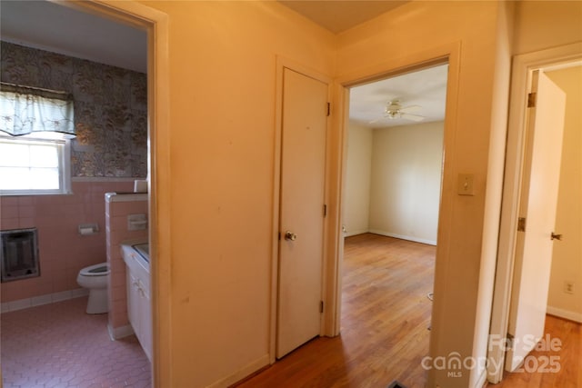 170 Heritage Ln, Salisbury, NC 28147 - hall featuring heating unit, light wood-style flooring, tile walls, and a wainscoted wall