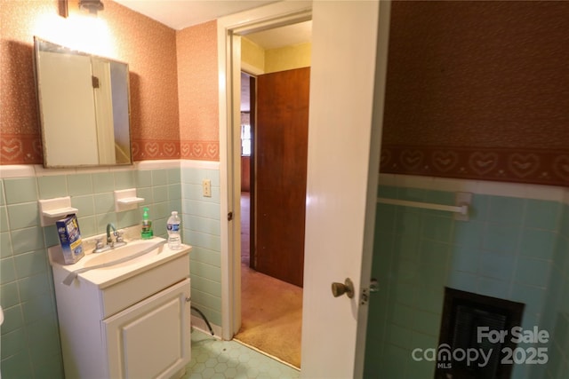 170 Heritage Ln, Salisbury, NC 28147 - half bath featuring wallpapered walls, tile walls, vanity, a wainscoted wall, and tile patterned floors