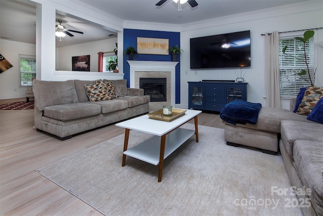6914 Evanton Loch Rd, Charlotte, NC 28278 - living room featuring a ceiling fan, wood finished floors, a glass covered fireplace, and crown molding