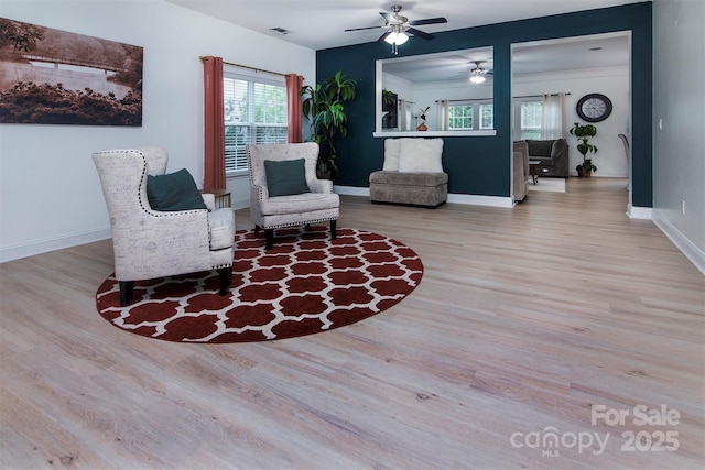 6914 Evanton Loch Rd, Charlotte, NC 28278 - living area featuring wood finished floors, a ceiling fan, plenty of natural light, and baseboards