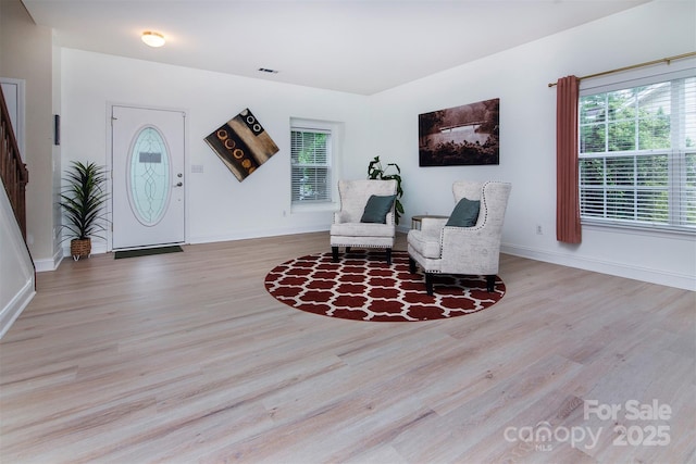6914 Evanton Loch Rd, Charlotte, NC 28278 - sitting room with wood finished floors, baseboards, and stairs