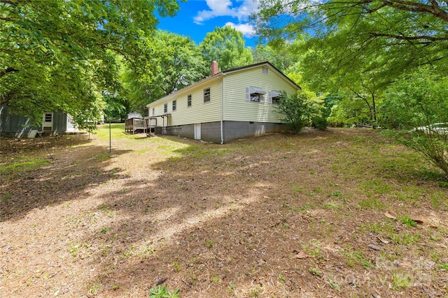 208 Lipe Rd, Troutman, NC 28166 - view of property exterior featuring a chimney, crawl space, a wooden deck, and view of wooded area