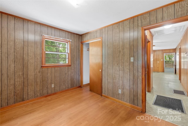 208 Lipe Rd, Troutman, NC 28166 - unfurnished bedroom with a closet, wood walls, wood finished floors, and baseboards