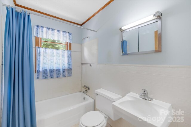 208 Lipe Rd, Troutman, NC 28166 - bathroom featuring shower / bath combo with shower curtain, a sink, tile walls, toilet, and ornamental molding
