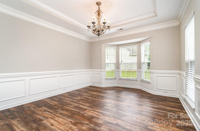 6922 Cascade Dream Ct, Huntersville, NC 28078 - empty room with a chandelier, dark wood-style flooring, wainscoting, a raised ceiling, and crown molding