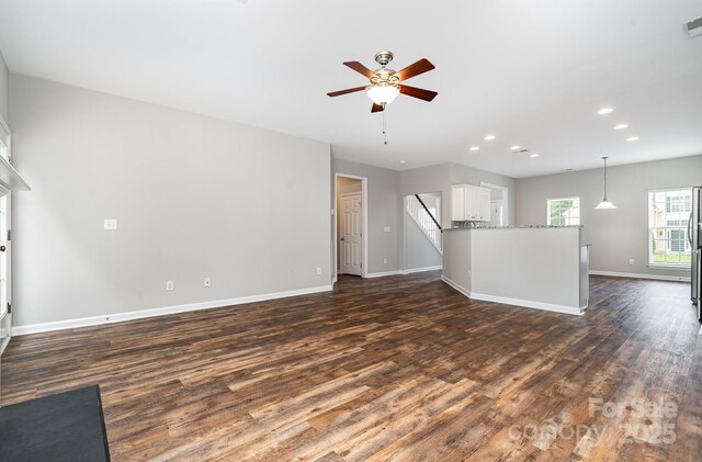 6922 Cascade Dream Ct, Huntersville, NC 28078 - unfurnished living room featuring dark wood-type flooring, ceiling fan, baseboards, and recessed lighting