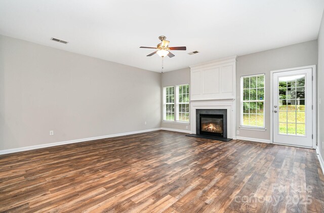 6922 Cascade Dream Ct, Huntersville, NC 28078 - unfurnished living room with a ceiling fan, plenty of natural light, dark wood-style floors, and a fireplace