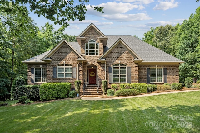 5812 Morgan Park Dr, Monroe, NC 28110 - traditional-style home featuring brick siding, a front yard, and roof with shingles