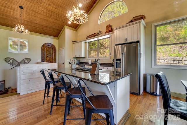 315 Black Bear Xing, Bryson City, NC 28713 - kitchen with stainless steel refrigerator with ice dispenser, a chandelier, high vaulted ceiling, wood ceiling, and a kitchen breakfast bar