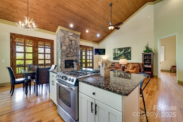 315 Black Bear Xing, Bryson City, NC 28713 - kitchen with stainless steel gas range oven, wood ceiling, french doors, a breakfast bar, and white cabinets