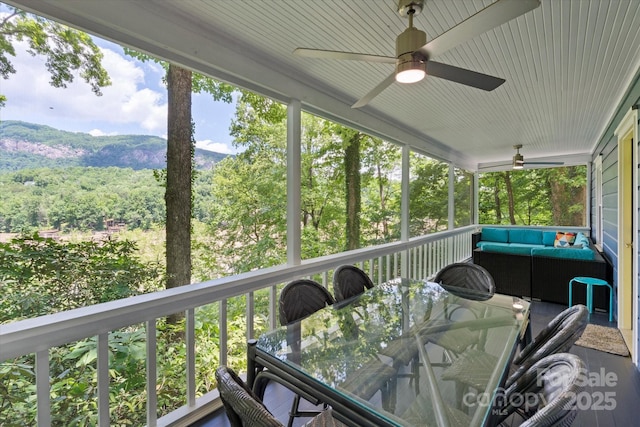 194 Mark Twain Dr, Lake Lure, NC 28743 - wooden deck with ceiling fan, an outdoor living space, outdoor dining area, a mountain view, and a forest view