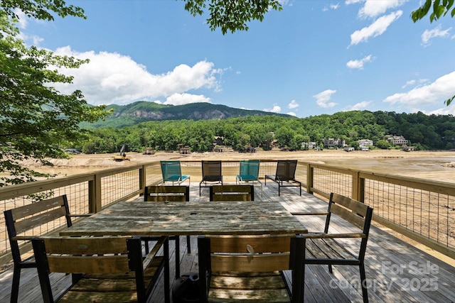 194 Mark Twain Dr, Lake Lure, NC 28743 - deck featuring outdoor dining area, a view of trees, and a mountain view