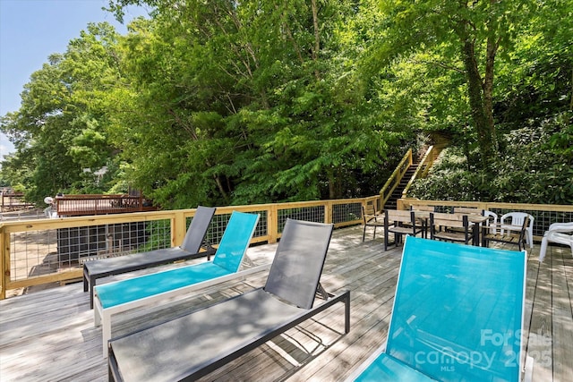 194 Mark Twain Dr, Lake Lure, NC 28743 - view of swimming pool featuring outdoor dining space, a wooden deck, and view of wooded area