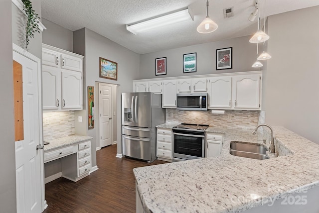 1310 Bellhook Pl NW, Concord, NC 28027 - kitchen featuring stainless steel appliances, a sink, a peninsula, dark wood-type flooring, and tasteful backsplash