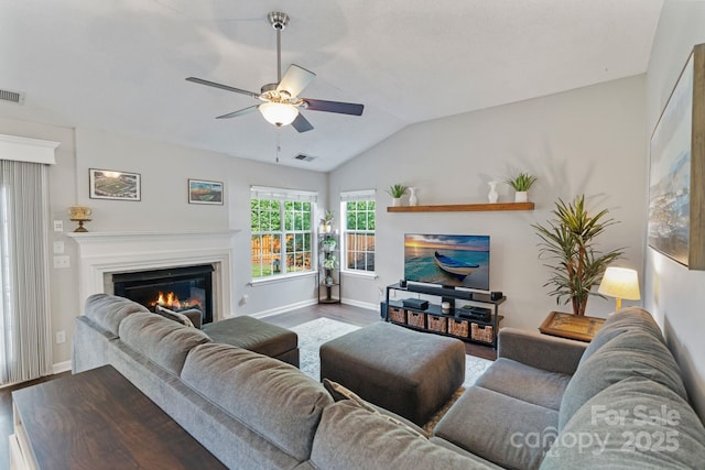 1310 Bellhook Pl NW, Concord, NC 28027 - living area featuring ceiling fan, wood finished floors, a glass covered fireplace, vaulted ceiling, and baseboards
