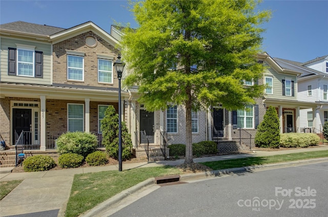 1225 Assembly St, Belmont, NC 28012 - view of property featuring brick siding and covered porch
