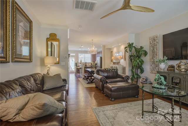 1225 Assembly St, Belmont, NC 28012 - living area with a chandelier, wood finished floors, crown molding, and a ceiling fan