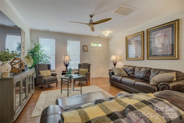 1225 Assembly St, Belmont, NC 28012 - living area featuring ornamental molding, a ceiling fan, healthy amount of natural light, and wood finished floors