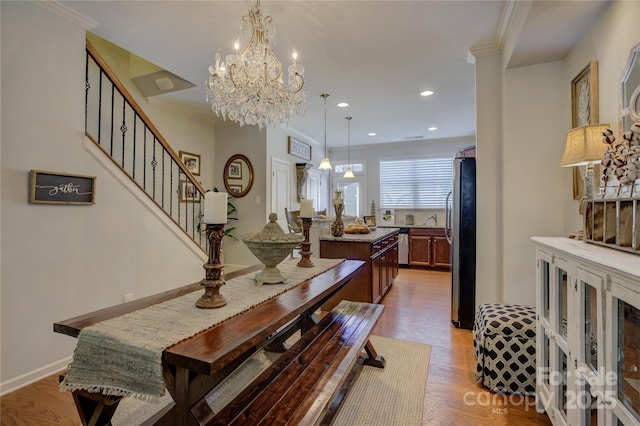 1225 Assembly St, Belmont, NC 28012 - dining space featuring light wood-style floors, stairway, a chandelier, recessed lighting, and crown molding