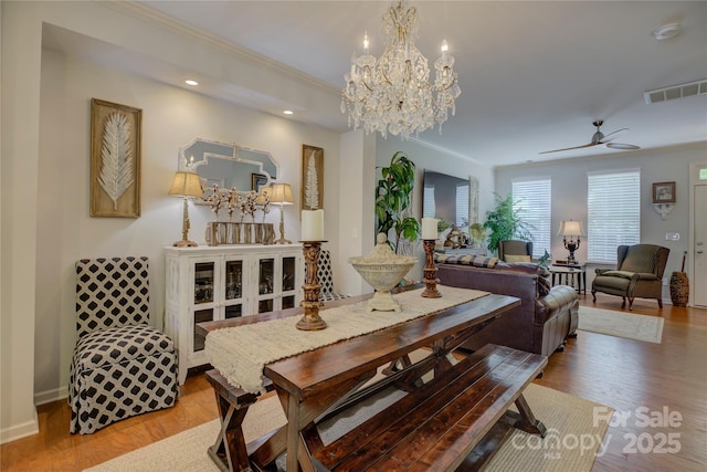 1225 Assembly St, Belmont, NC 28012 - dining space with wood finished floors, a chandelier, crown molding, a ceiling fan, and recessed lighting