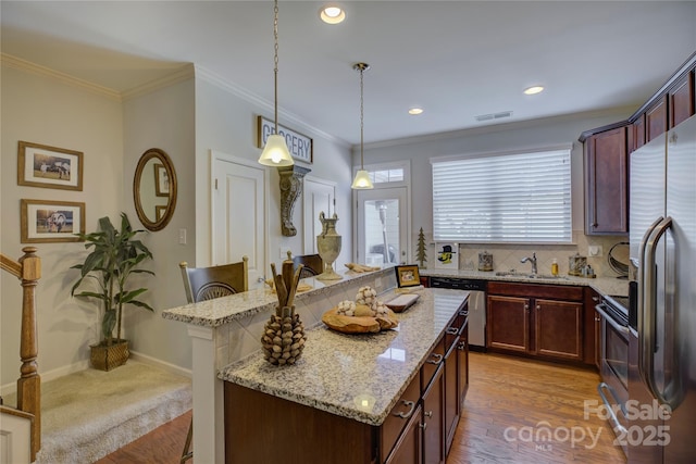 1225 Assembly St, Belmont, NC 28012 - kitchen with appliances with stainless steel finishes, a sink, light stone counters, a center island, and hanging light fixtures