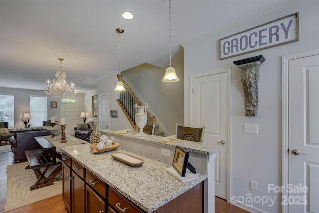 1225 Assembly St, Belmont, NC 28012 - kitchen featuring a chandelier, open floor plan, dark wood-style floors, decorative light fixtures, and a kitchen island