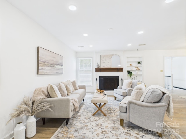 4905 Chestnut Lake Dr, Charlotte, NC 28227 - living area with light wood finished floors, built in features, recessed lighting, and a fireplace