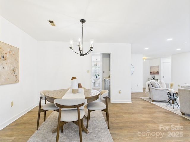 4905 Chestnut Lake Dr, Charlotte, NC 28227 - dining area featuring a chandelier, light wood finished floors, baseboards, and recessed lighting