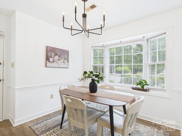 4905 Chestnut Lake Dr, Charlotte, NC 28227 - dining area with a chandelier, wood finished floors, and baseboards