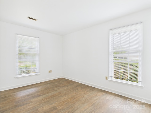 4905 Chestnut Lake Dr, Charlotte, NC 28227 - unfurnished room featuring wood finished floors, healthy amount of natural light, and baseboards