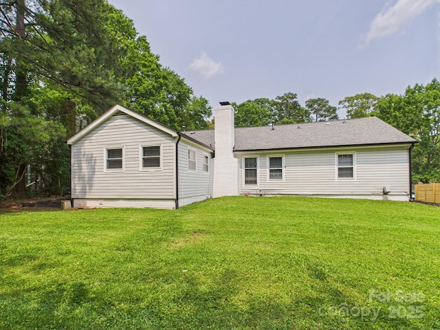 4905 Chestnut Lake Dr, Charlotte, NC 28227 - rear view of property with a chimney, a lawn, and roof with shingles