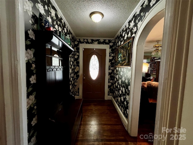 522 W Congress St, Lincolnton, NC 28092 - entrance foyer featuring wallpapered walls, crown molding, a textured ceiling, arched walkways, and dark wood-style flooring
