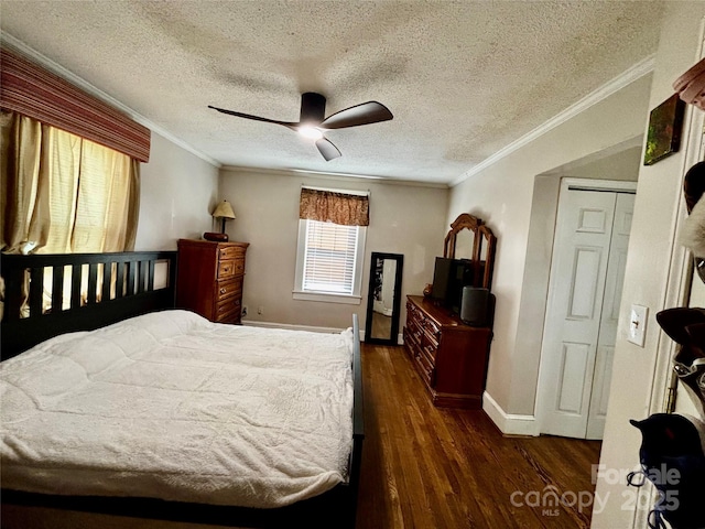 522 W Congress St, Lincolnton, NC 28092 - bedroom with baseboards, dark wood finished floors, ornamental molding, ceiling fan, and a textured ceiling