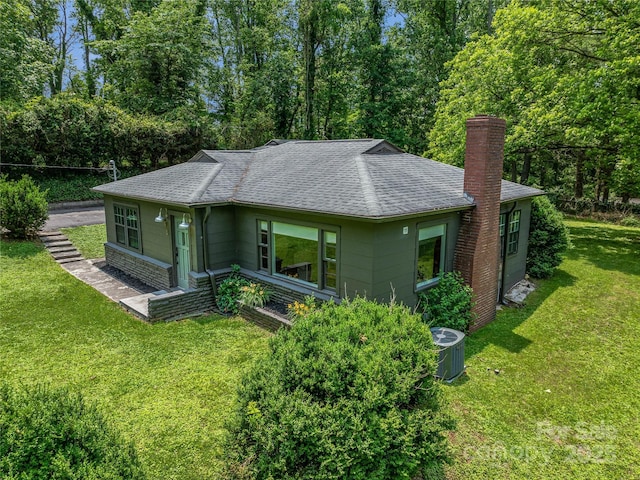 90 W Skyland Cir Unit 1, Asheville, NC 28804 - back of property with roof with shingles, a chimney, a yard, and cooling unit